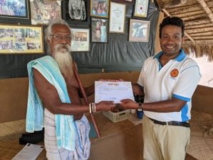 Dr. Oshan Wedage receives his Humanitarian Award from Chief Uruwarige Wanniyalaeto at Dambana Village.